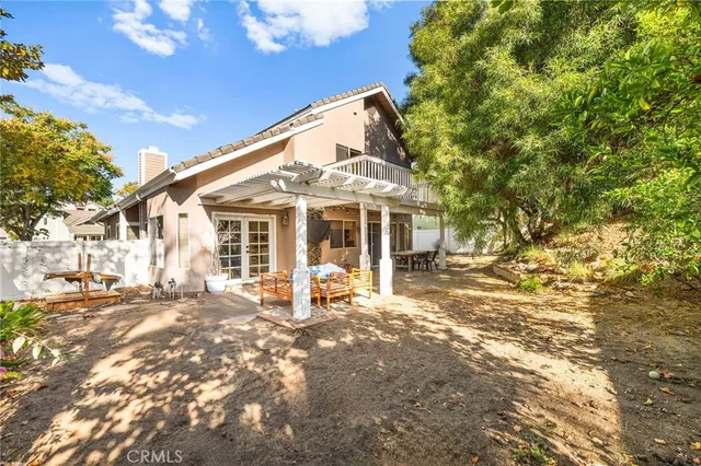 a patio with glass top table and chairs