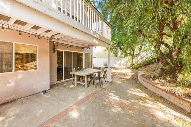 a backyard of a house with yard and outdoor seating