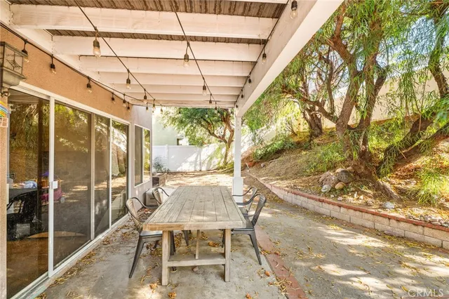 a backyard of a house with barbeque oven table and chairs