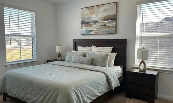 a bedroom with a bed and a window