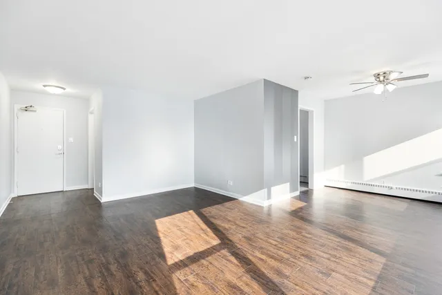 a view of an empty room with wooden floor