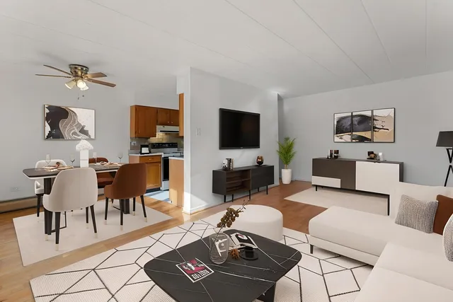 a living room with furniture a rug and a flat screen tv