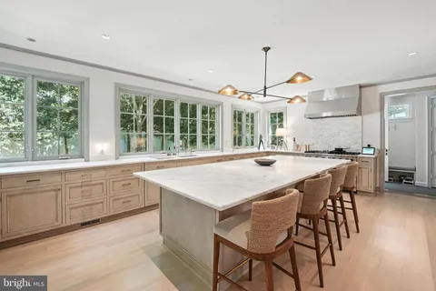 a kitchen with a table chairs sink and cabinets