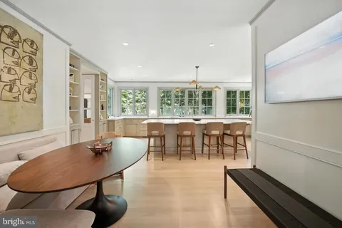 a dining room with furniture and a large window