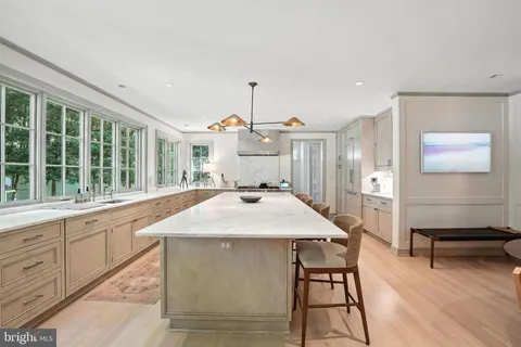 a kitchen with a table chairs and wooden floor