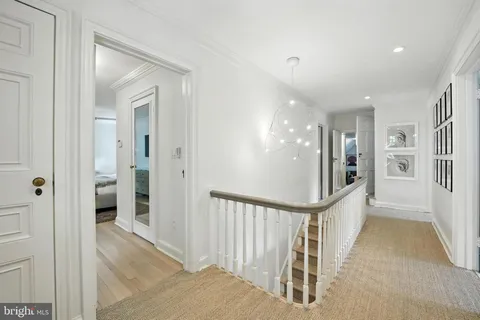 a view of a hallway with wooden floor and entryway