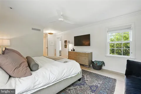 a bedroom with a bed and a television