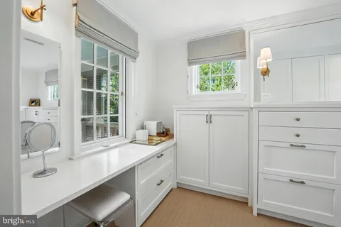a room with a window cabinet and mirror