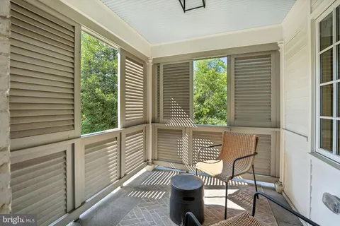 a balcony with table and chairs