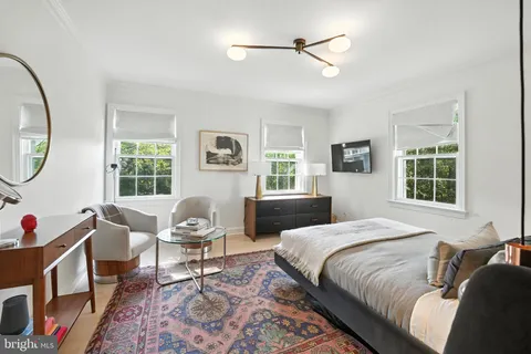 a bedroom with a bed chair and a window