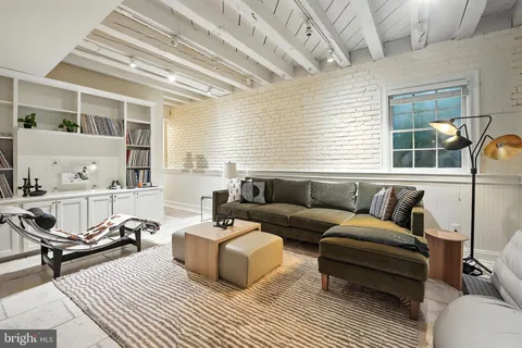 a living room with furniture a rug and a window