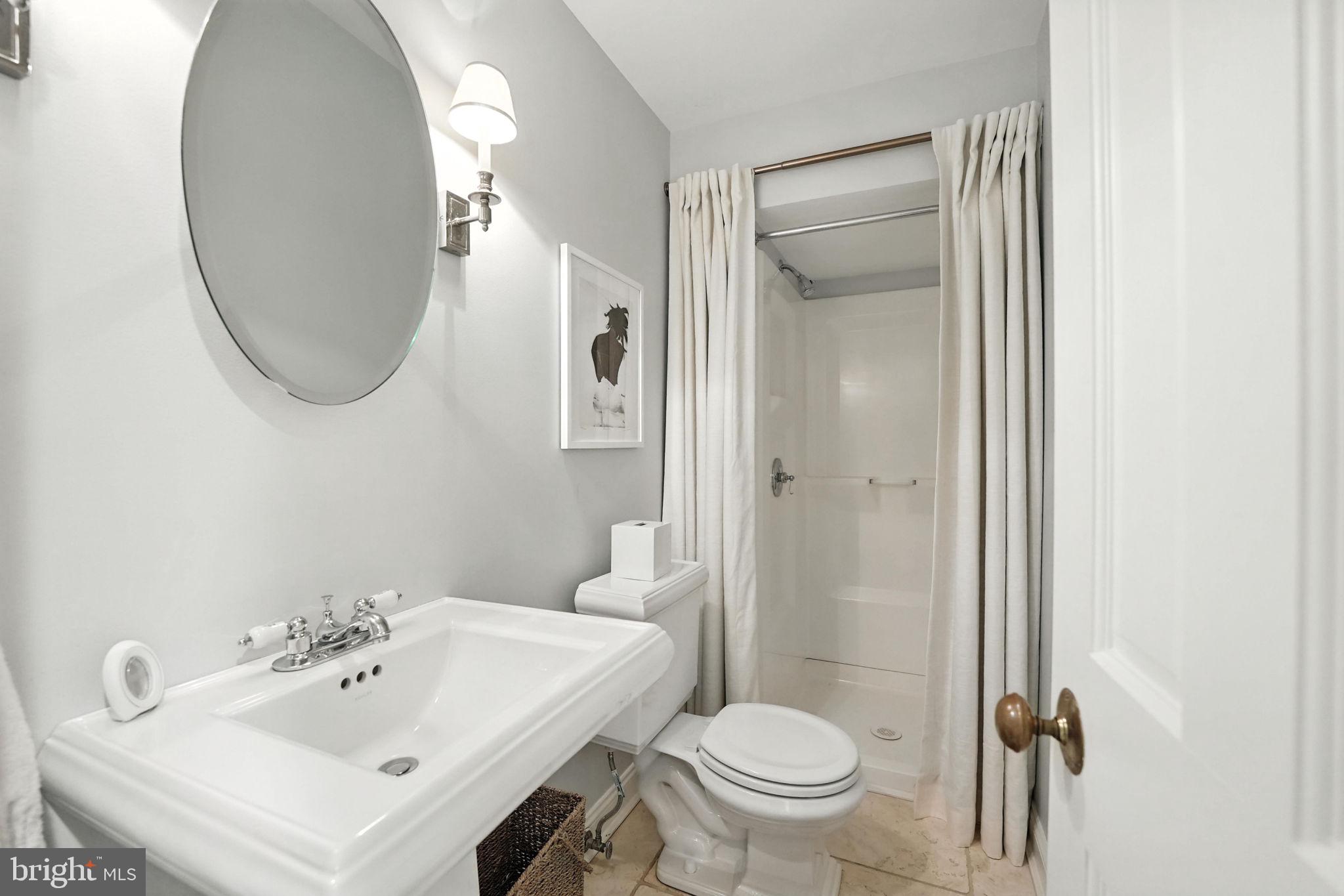 1804 45th Street Northwest Washington, DC 20007 - Photo 43 of 52 a bathroom with a sink a toilet and a mirror