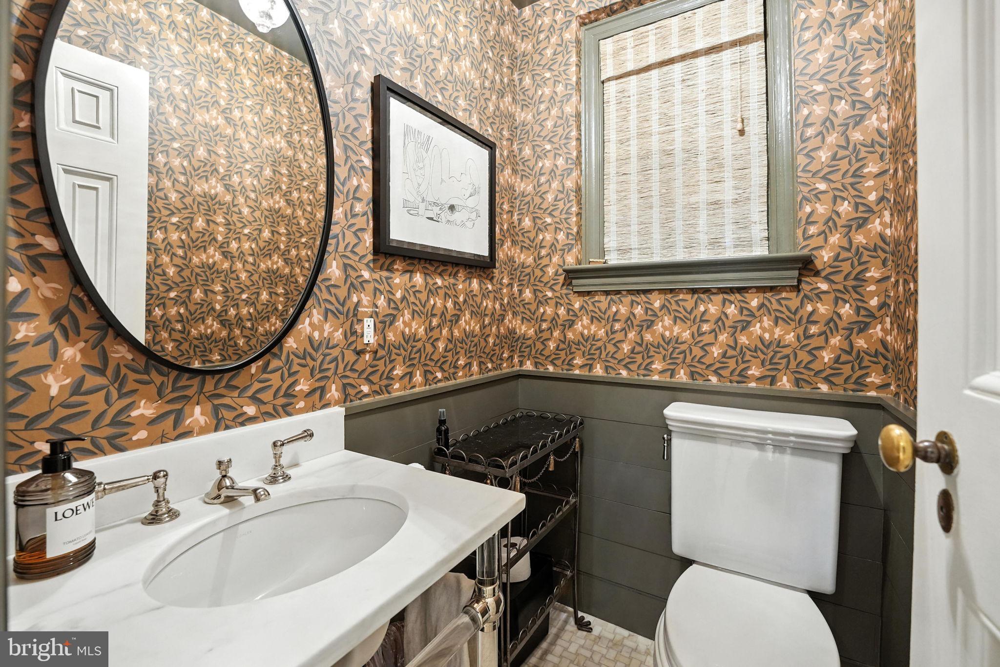 1804 45th Street Northwest Washington, DC 20007 - Photo 10 of 52 a bathroom with a toilet sink and mirror