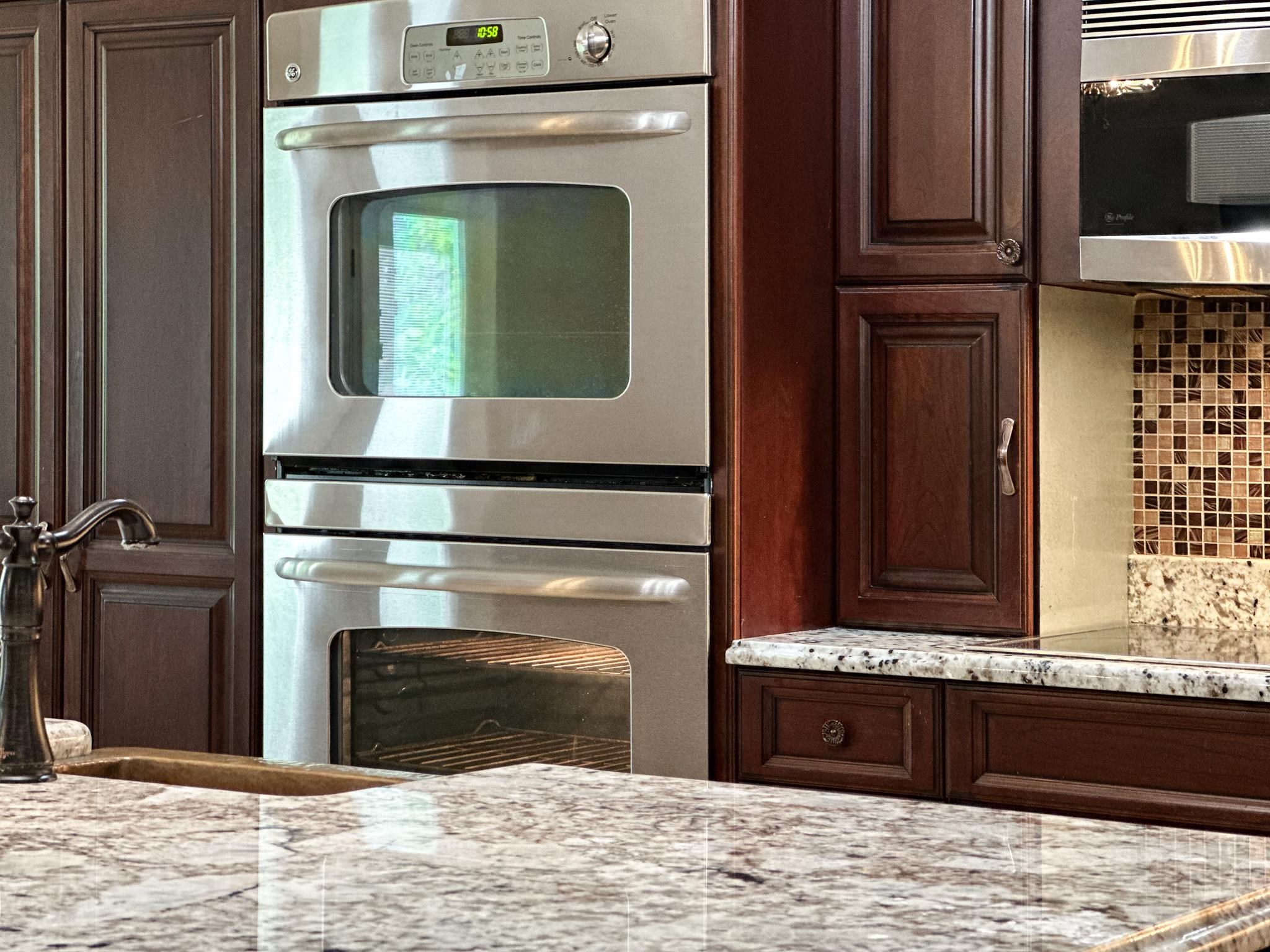 1426 Roman Road Mount Sidney, VA 24467 - Photo 27 of 46 a bathroom with a granite countertop sink and a stove
