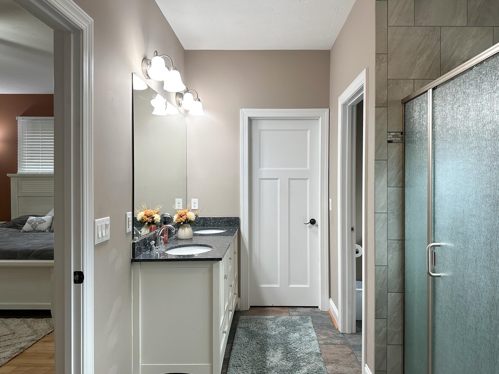 1426 Roman Road Mount Sidney, VA 24467 - Photo 35 of 46 a bedroom with a bed and a chandelier