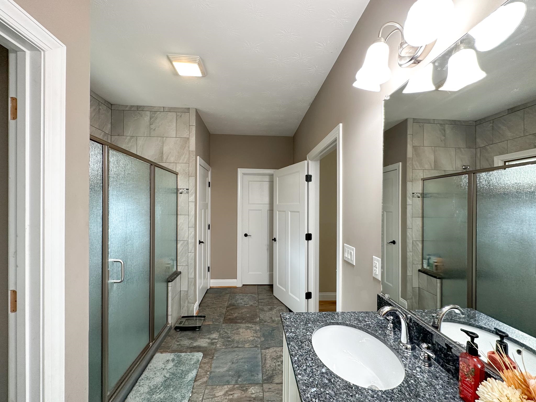 1426 Roman Road Mount Sidney, VA 24467 - Photo 38 of 46 a bathroom with a double vanity sink mirror and shower