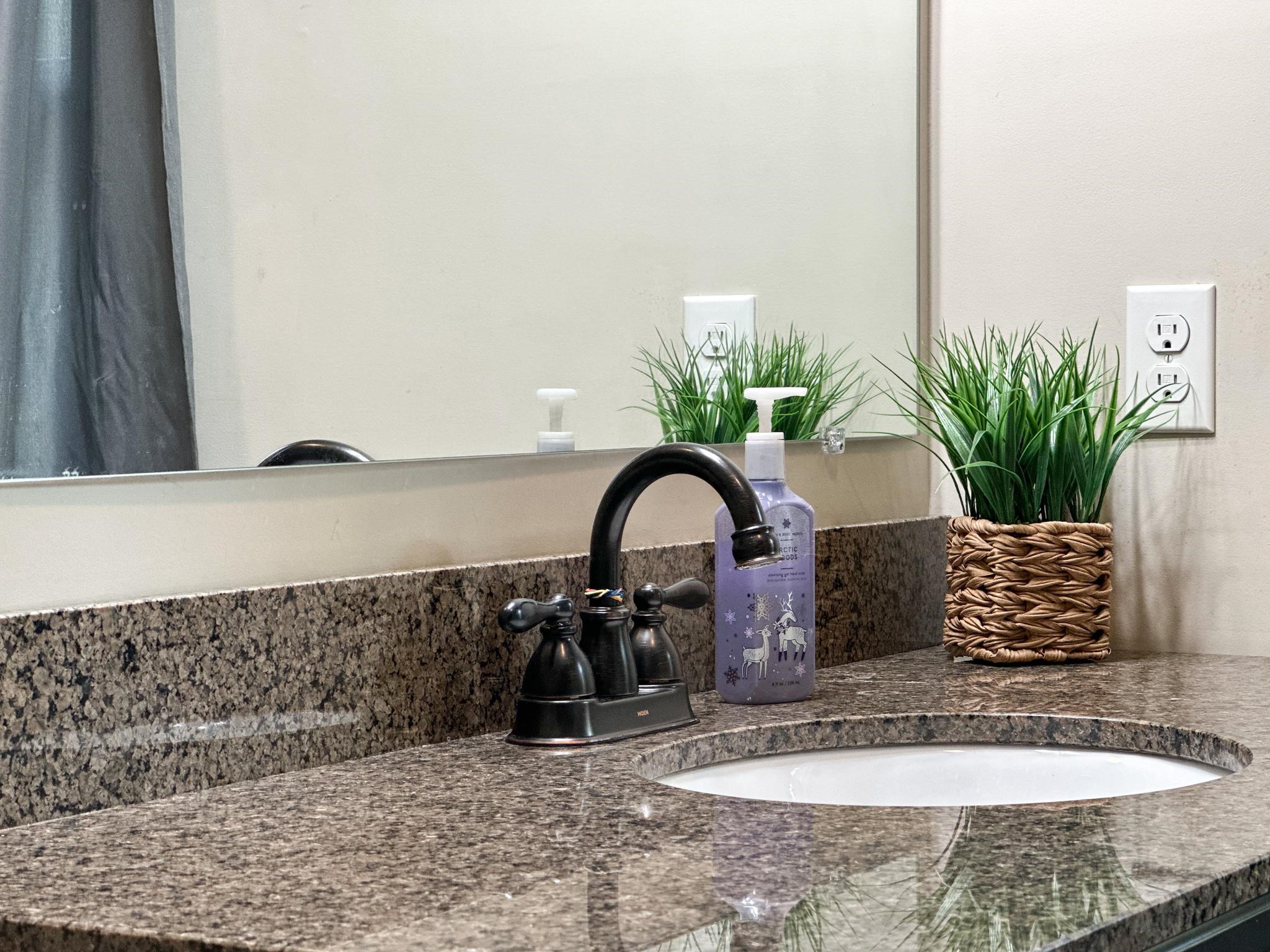 1426 Roman Road Mount Sidney, VA 24467 - Photo 41 of 46 a view of a sink granite counter top a potted plant and a sink