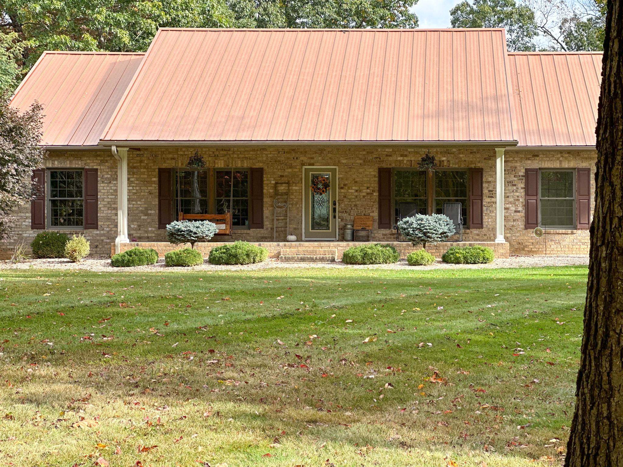 1426 Roman Road Mount Sidney, VA 24467 - Photo 7 of 46 a front view of a house with a garden and porch