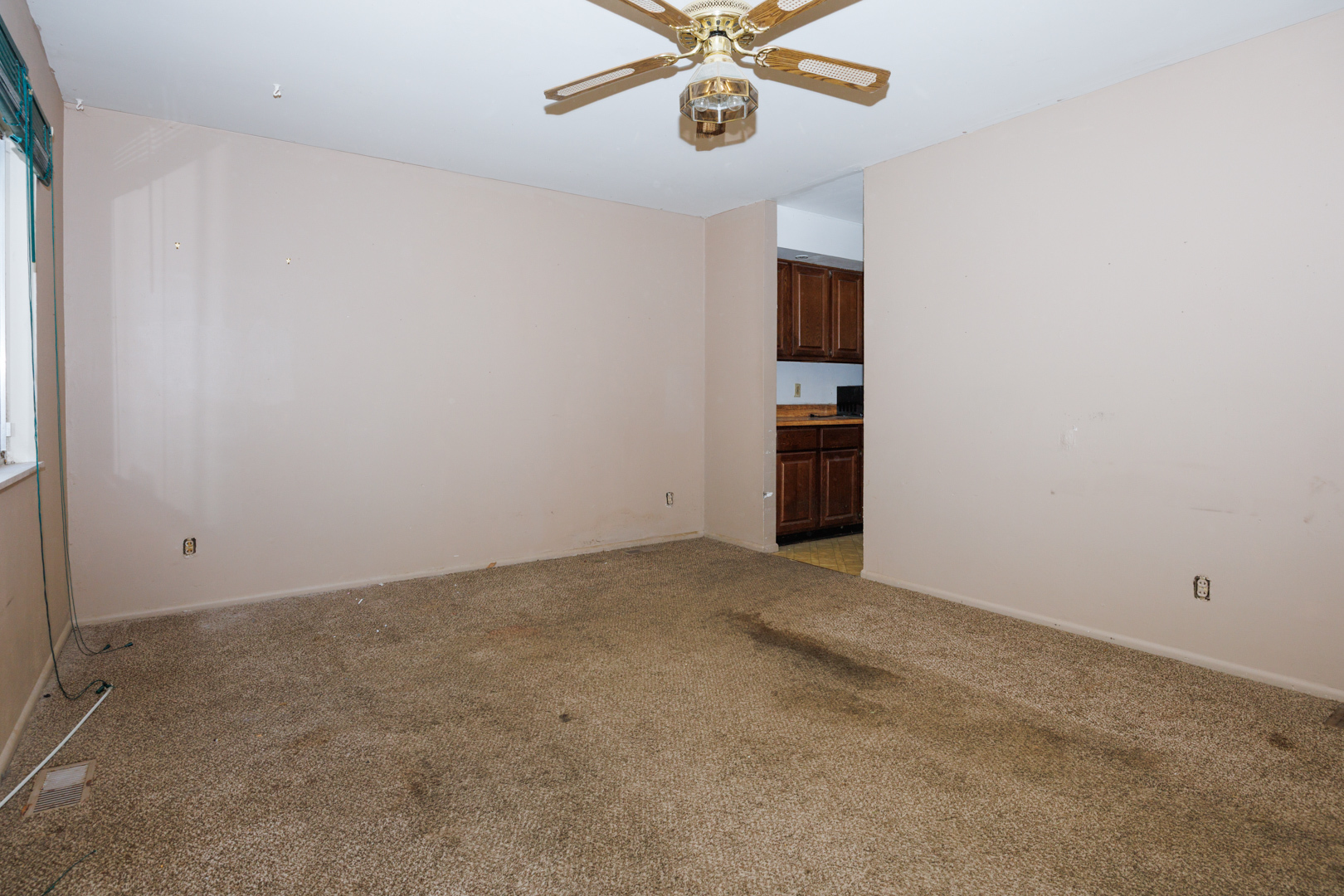 1307 Glenwood Road Bloomington, IL 61704 - Photo 2 of 21 an empty room with a chandelier fan and windows