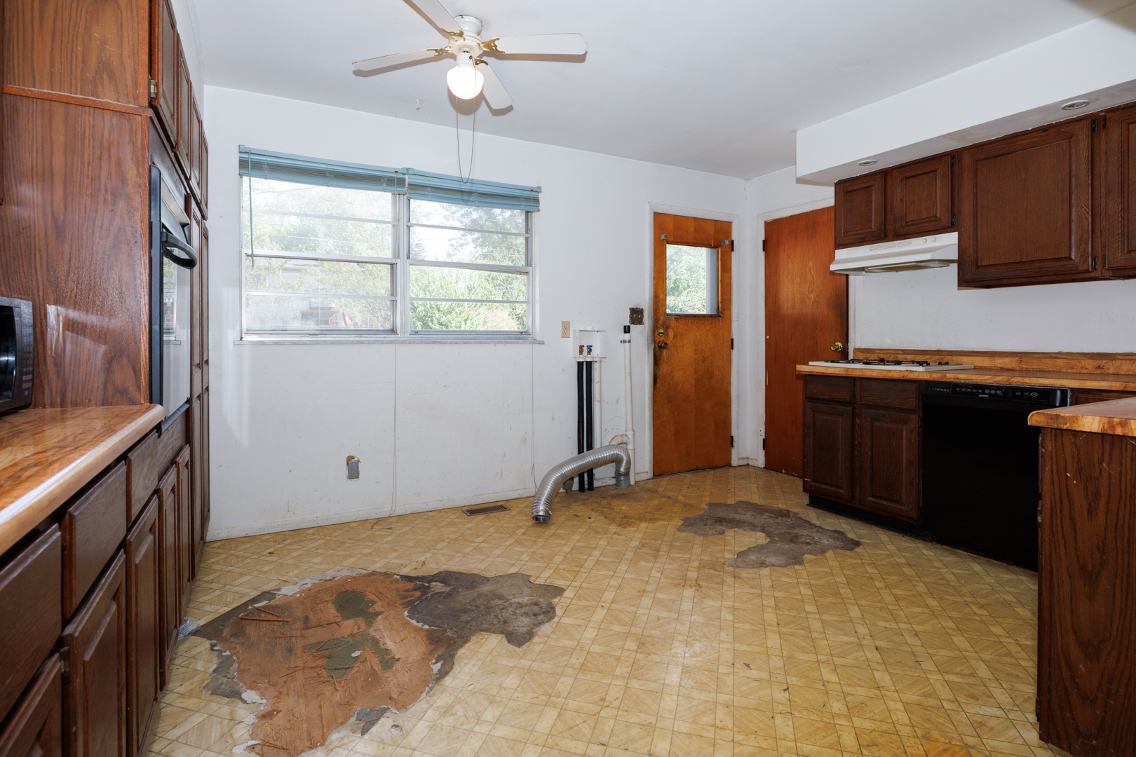 1307 Glenwood Road Bloomington, IL 61704 - Photo 6 of 21 a view of a kitchen with a sink cabinets and window