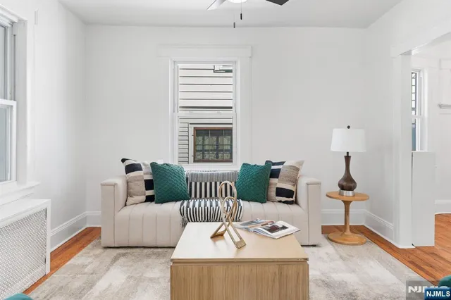 a kitchen with stainless steel appliances a sink a stove a refrigerator cabinets and a dining table