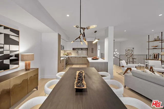 a living room with furniture a wooden floor and a chandelier