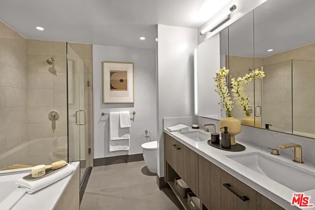 a bathroom with a double vanity sink toilet and shower