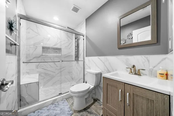 a bathroom with a toilet sink and shower