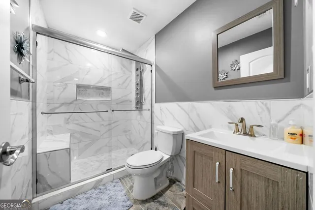 a bathroom with a toilet sink and shower