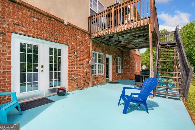 a view of a house with a patio and wooden deck