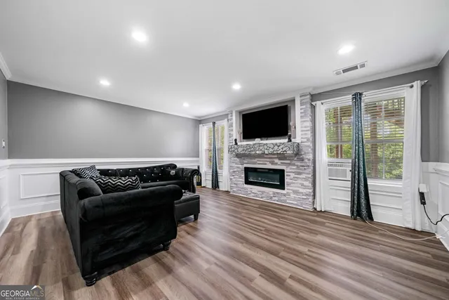 a living room with furniture a fireplace and a flat screen tv