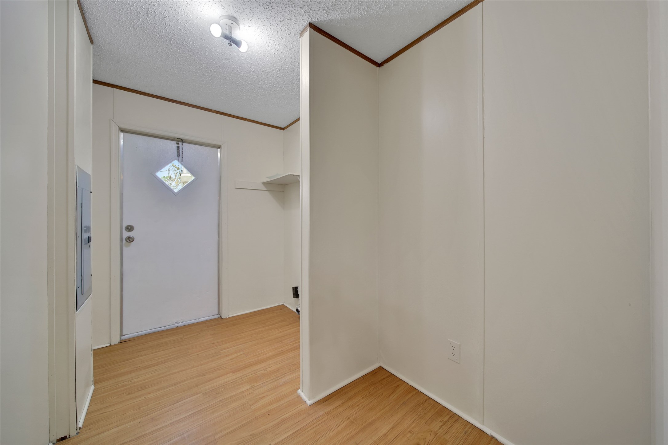 2 Jacob Street Huntsville, TX 77320 - Photo 11 of 20 a view of an empty room with wooden floor and a ceiling fan