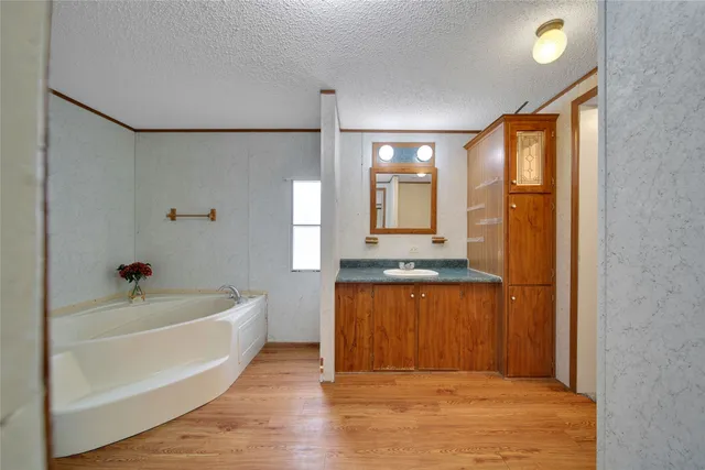 a spacious bathroom with a tub sink and shower