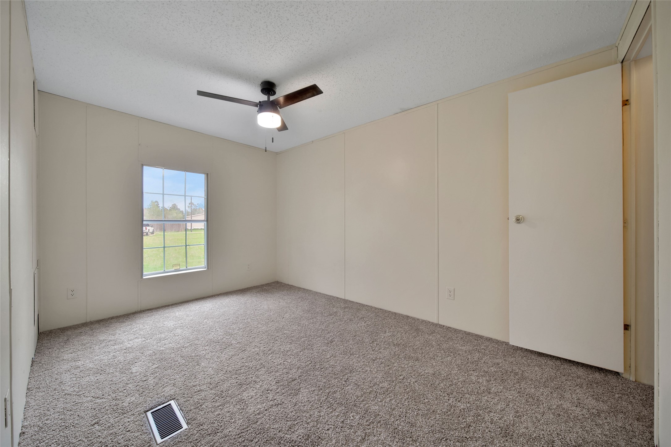 2 Jacob Street Huntsville, TX 77320 - Photo 20 of 20 an empty room with windows and fan