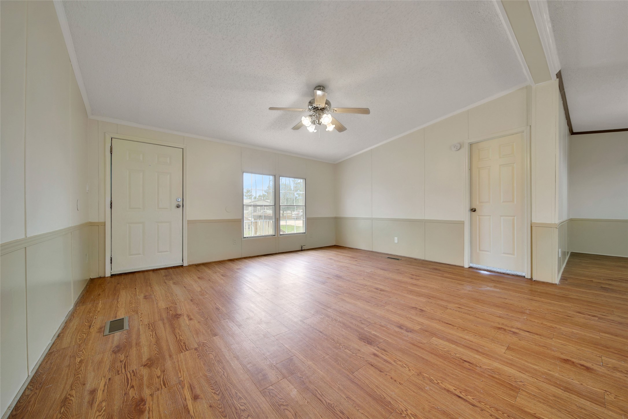 2 Jacob Street Huntsville, TX 77320 - Photo 7 of 20 an empty room with wooden floor chandelier fan and windows