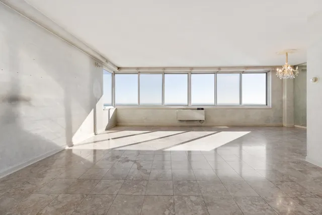 a view of a livingroom with a dinning table and chandelier
