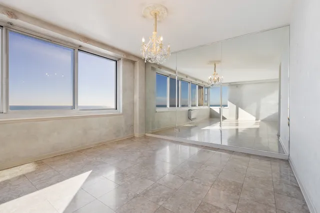 a view of a kitchen with sink and cabinets