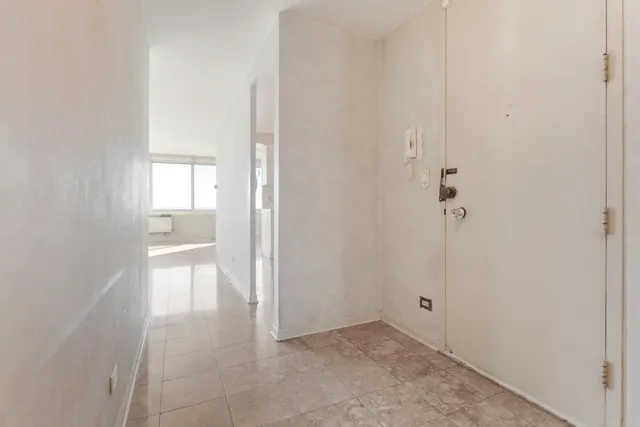 a view of an empty room and fire place