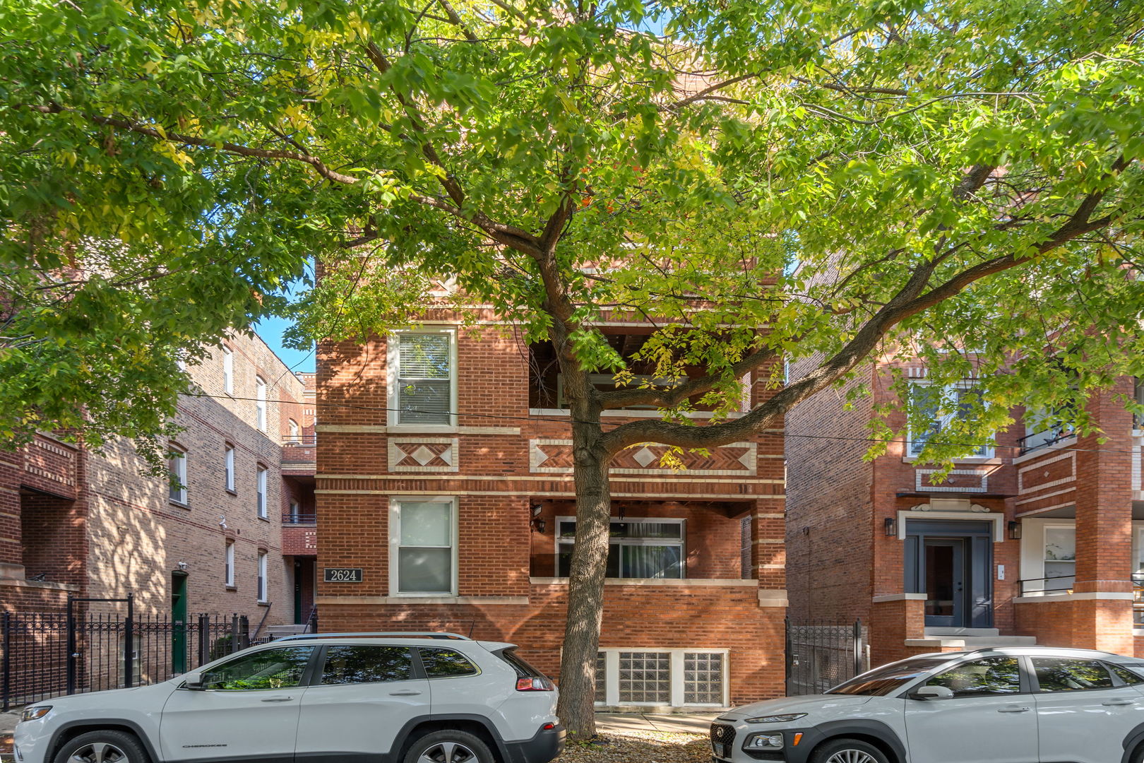 front view of a building with a tree