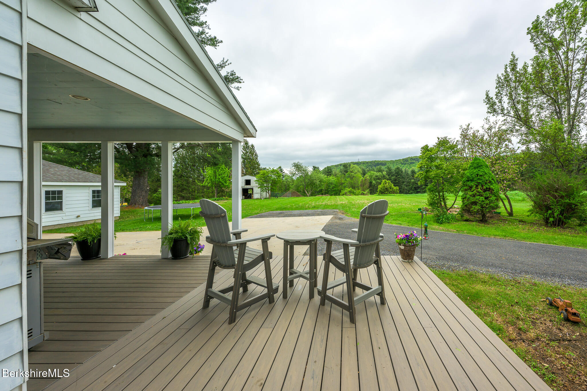 955 Barker Road Pittsfield, MA 01201 - Photo 2 of 35 a view of a deck with table and chairs and floor to ceiling window with wooden floor