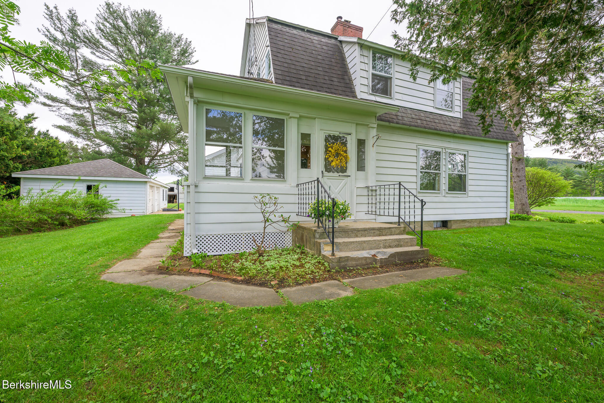 955 Barker Road Pittsfield, MA 01201 - Photo 29 of 35 a front view of a house with a garden and yard