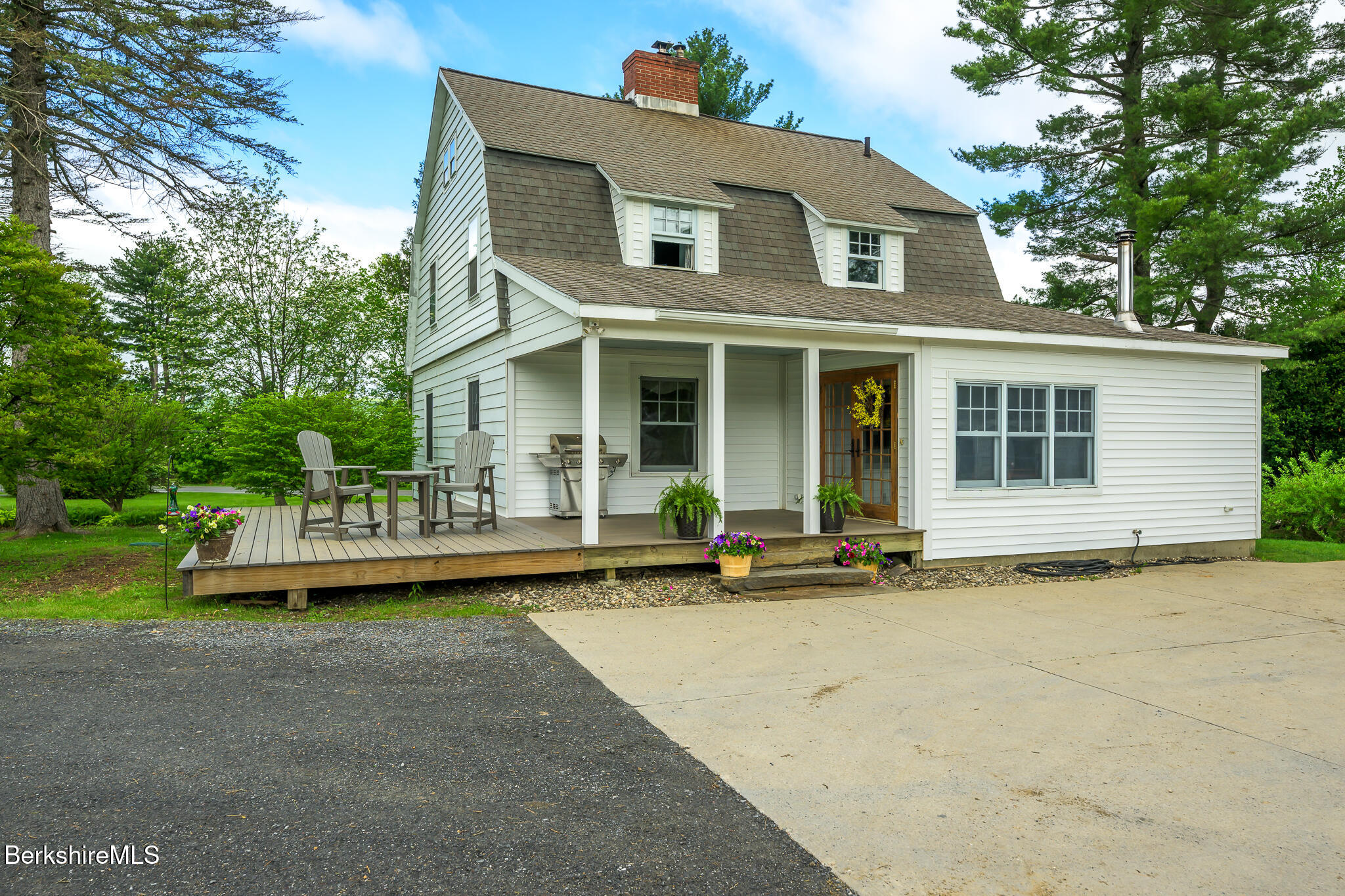 955 Barker Road Pittsfield, MA 01201 - Photo 3 of 35 a front view of a house with a garden and porch