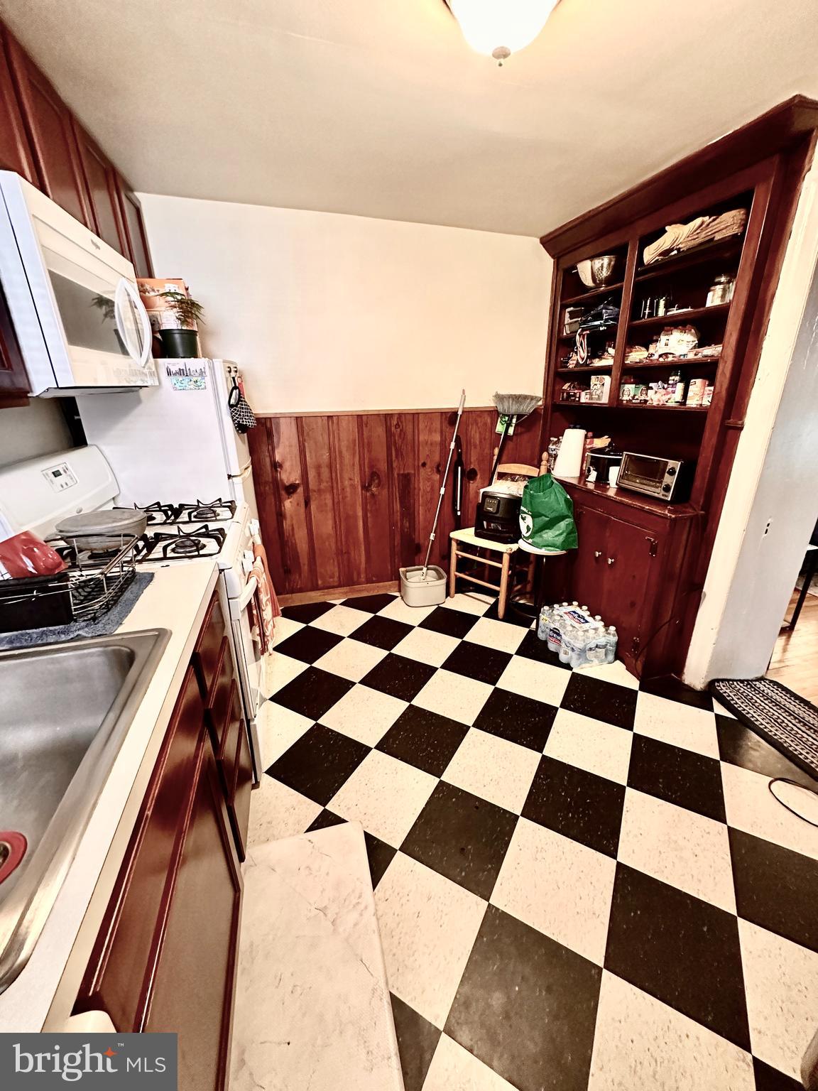243 West Rittenhouse Street, Unit 2C Philadelphia, PA 19144 - Photo 6 of 9 a room with black and white checkered floor