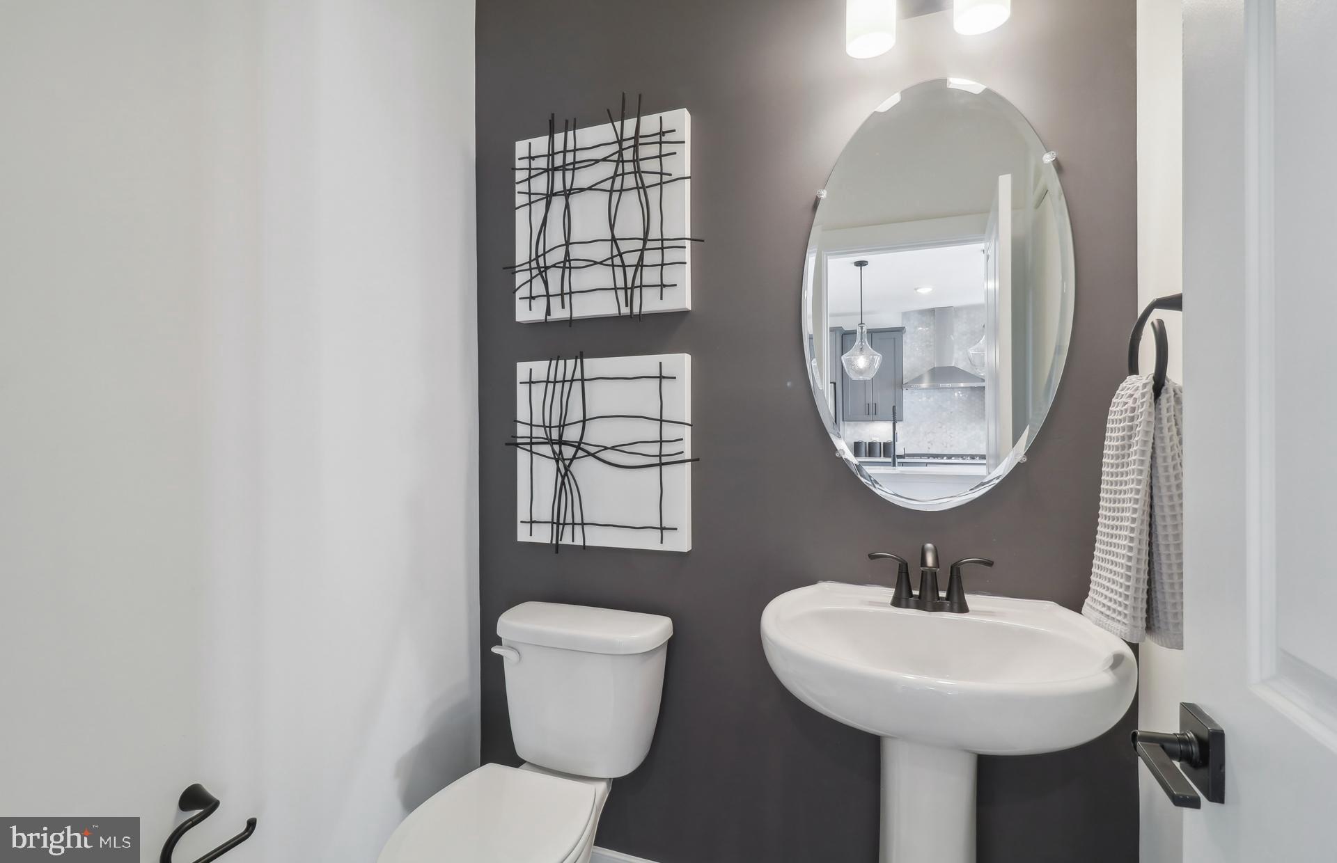 16146 Frederick Road Rockville, MD 20850 - Photo 11 of 41 a bathroom with a toilet a sink and a mirror
