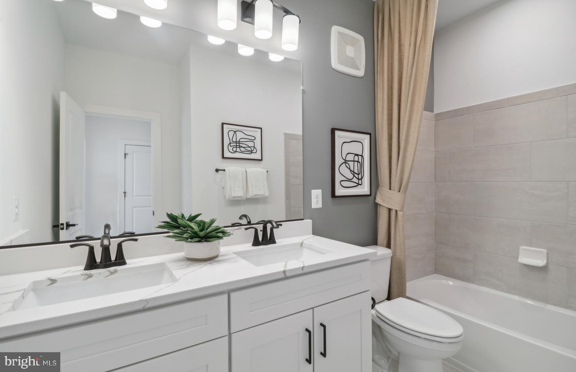 16146 Frederick Road Rockville, MD 20850 - Photo 22 of 41 a bathroom with a sink a toilet a mirror and shower