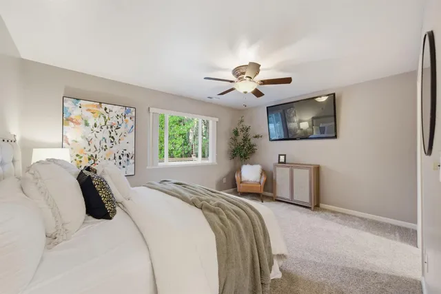 a view of a house with backyard and trees