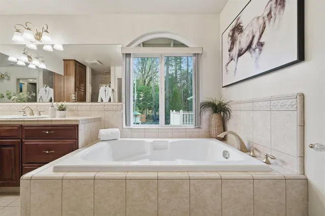 a view of backyard with swimming pool and trees in the background