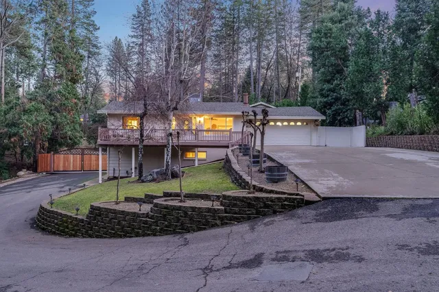 a living room with furniture a large window and a chandelier