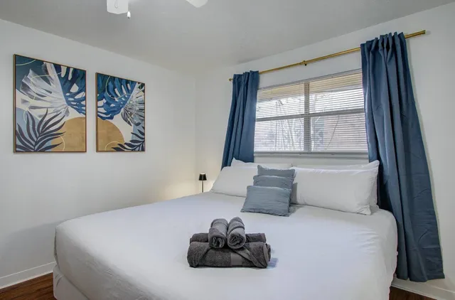 a bedroom with a bed and a painting on the wall