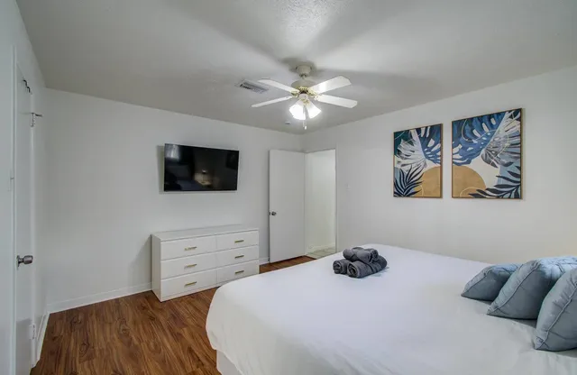 a bedroom with a bed and a flat screen tv